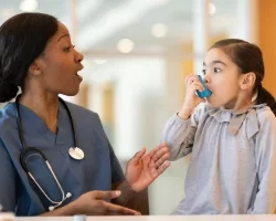 photo of a nurse helping a child with a breathing device