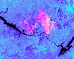 Daytime average land surface temperature over June 2022 from ECOSTRESS, an instrument on the ISS. Warm colors highlight the City of Huntsville, which is surrounded by central North Alabama. In both color gradients, darker colors represent higher temperatures. The Tennessee River, together with Wheeler Lake (left) and Lake Guntersville (right), appear black. Surface temperature is one factor that can help the local government decide where to focus tree-planting efforts to mitigate urban heat.