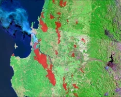 The data come from Landsat 9 OLI and MODIS satellites. The data shows surface reflectance imagery and combined (Terra and Aqua) MODIS burned areas from wildland fires in February 2023. The image shows parts of South-Central Chile covering Región del Maule, Región del Bío-Bío, and Región de La Araucanía. The processed data show burned areas in the region of interest from wildland fires and the smog from the fires. Red patches indicate burned areas.