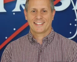 Kevin picutred in front of the original NASA logo