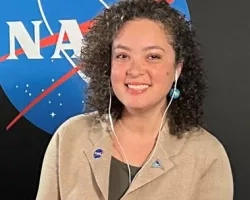 Natasha Sadoff pictured in front of a black backdrop with the NASA logo