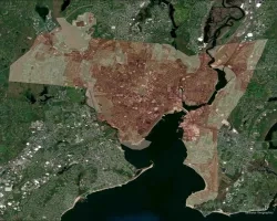 Aerial imagery of New Haven, Connecticut with the average land surface temperature (LST) for 2022 overlaid on top of the image. Areas of higher average temperature are shown in dark red, and areas of comparatively lower average temperature are shown in light pink. In this project, LST analysis is combined with an analysis of vegetative cover and socioeconomic characteristics to identify the neighborhoods most at-risk from heat-related impacts to prioritize for tree planting initiatives.