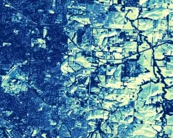  Land use land cover unsupervised classification derived from Landsat 9 OLI-2 TOA imagery acquired in spring 2023. The image shows the city of Lincoln, Nebraska. Lighter blue and greens show vegetation and agriculture, and darker blues show the urban area (left) invading the river (right). Heavily urbanized areas nearby rivers are at higher risk of flooding and are candidates for the Audubon Great Plains' environmental restoration and flood mitigation initiative.