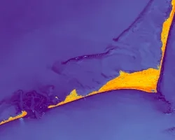 Modified normalized water difference index (mNDWI) composite processed from Landsat 8 OLI data. This composite was created from 16 images of the southern cusp of Cape Hatteras National Seashore captured between February 2023 and February 2024. The yellow-orange shapes represent barrier islands, surrounded by shades of blue that indicate water. Processing images by calculating mNDWI is useful in delineating shoreline change over time. 