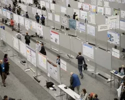 photo of hall with bulletin boards and people