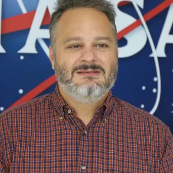 Image of David Barbato in front of the traditional NASA logo