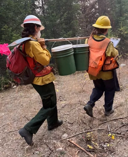 photo of people carrying buckets