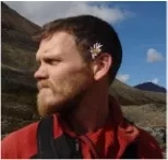 photo of man with flower behind ear